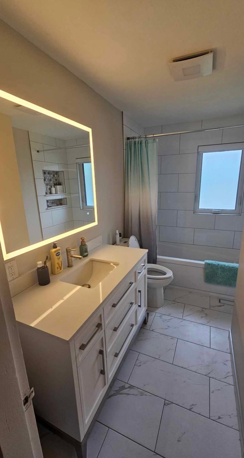 Finished bathroom with vanity and tub installed by Penberg Mechanical